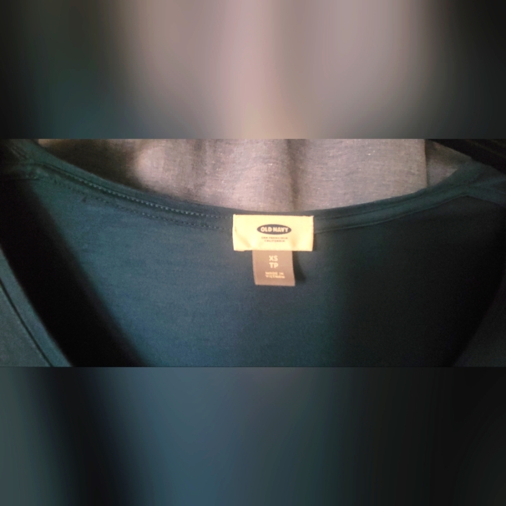 Blue green blouse with a ballet neckline.